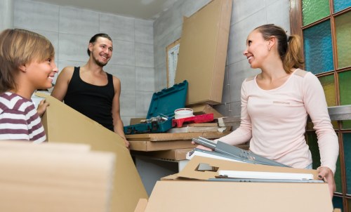 Removal team using protective moving equipment during a Harrow house move