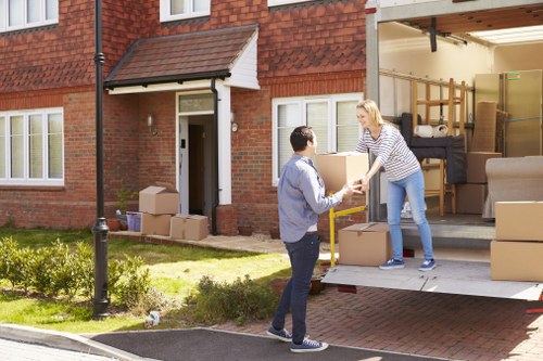 Professional movers handling desks and office equipment in Harrow