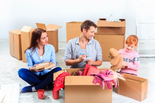 Local removals team handling furniture in a Harrow residential street