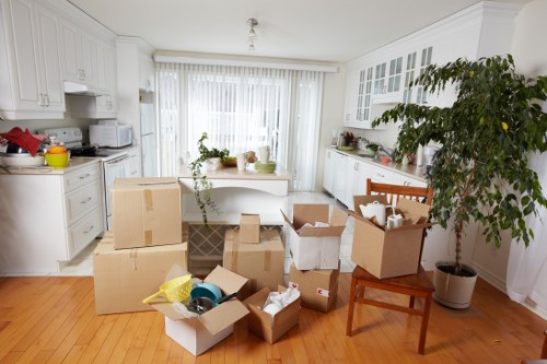 Removal team loading boxes and furniture into a van