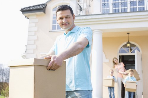 Professional movers handling boxes and furniture during a Harrow move