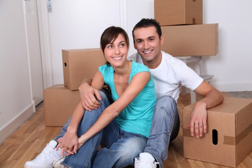 Mover handling fragile household items with protective wrapping