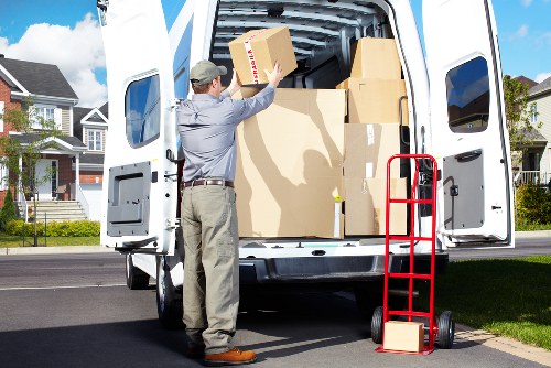 Staff member checking a complaint log for a moving company