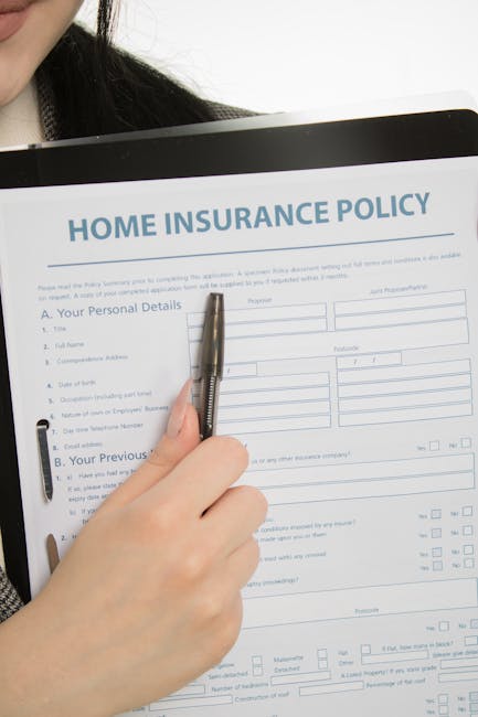 A person holding a silver pen is filling out a home insurance policy form on a clipboard, which includes sections for personal details, previous insurance information, and related questions. The person is partially visible, with only their hand and part of their dark clothing and hair shown. The background is plain and white, emphasizing the form and the act of completing paperwork. This image relates to home documentation processes often associated with house removals or moving preparations, which are part of comprehensive residential relocation services offered by Removal Companies Harrow, as referenced on their website at https://removalcompaniesharrow.co.uk, particularly in the context of checking insurance and licensing credentials for a house move in Harrow.