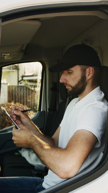 A person holding a silver pen is filling out a home insurance policy form on a clipboard, which includes sections for personal details, previous insurance information, and related questions. The person is partially visible, with only their hand and part of their dark clothing and hair shown. The background is plain and white, emphasizing the form and the act of completing paperwork. This image relates to home documentation processes often associated with house removals or moving preparations, which are part of comprehensive residential relocation services offered by Removal Companies Harrow, as referenced on their website at https://removalcompaniesharrow.co.uk, particularly in the context of checking insurance and licensing credentials for a house move in Harrow.